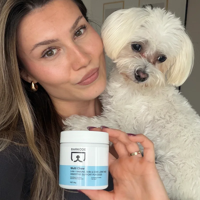 Owner holding her white Maltese and a jar of Multi Chew